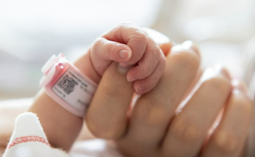 a baby is hand holding a finger