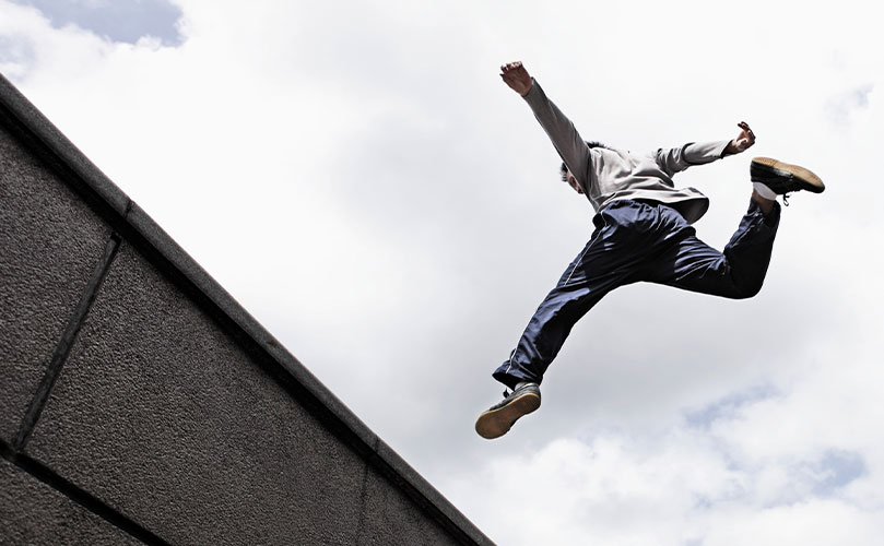 A person jumping from one building to another