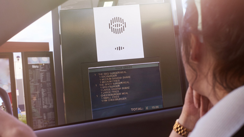 A woman is watching the results of the analysis on the monitor