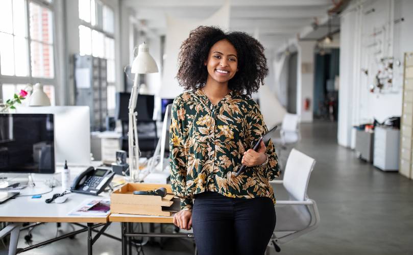 Portrait of a young woman standing in office