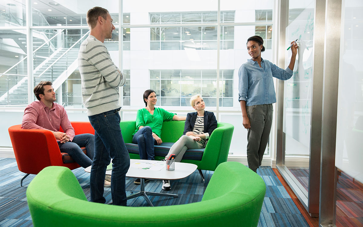 5 people having an informal meeting in a lounge area