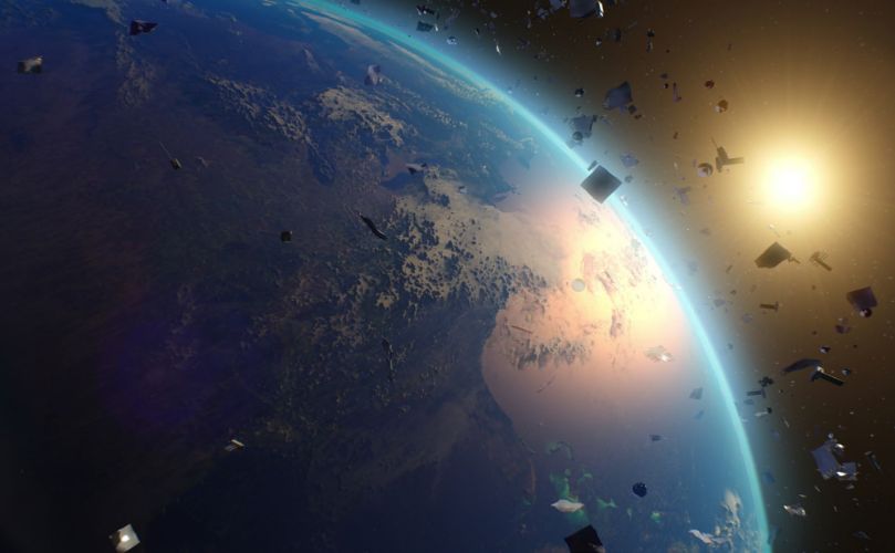 Blick auf die Erde aus dem All mit sichtbarem Sonnenaufgang und Weltraumschrott