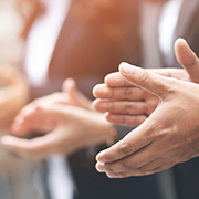 会議やイベントで拍手する人々の手元