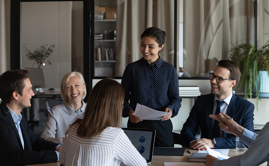 Business people in a meeting room engaged in a friendly discussion