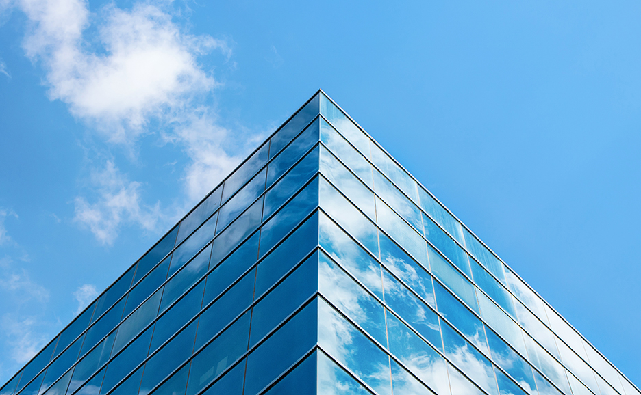 A glass building with sky reflection