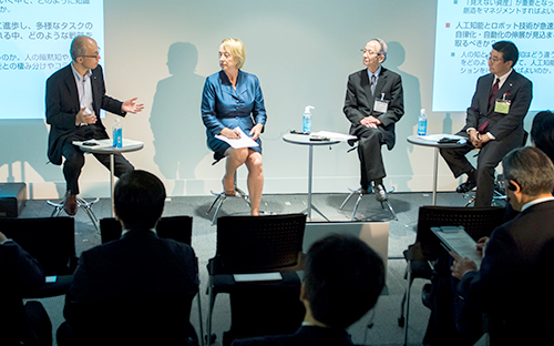 Panel discussion with four speakers on stage