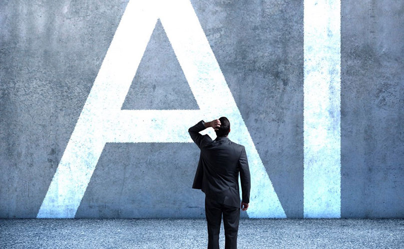 A man looking at a wall that has 'AI' written on it