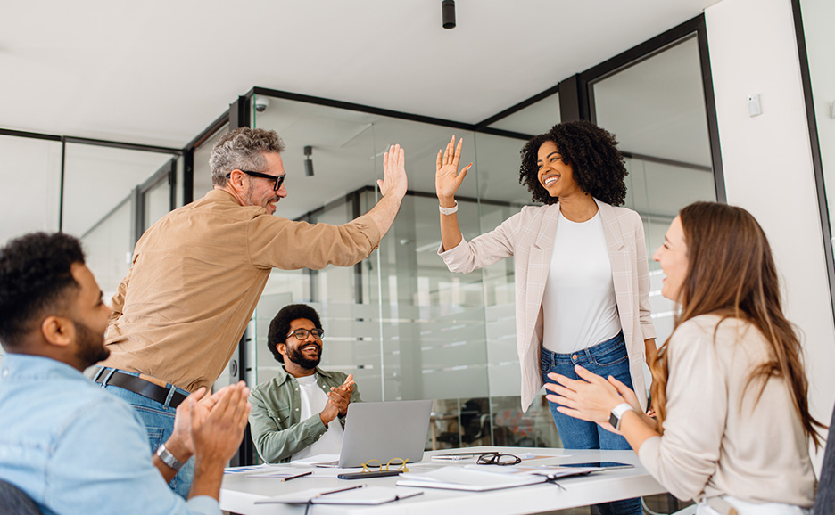 Business team high-fiving in an office