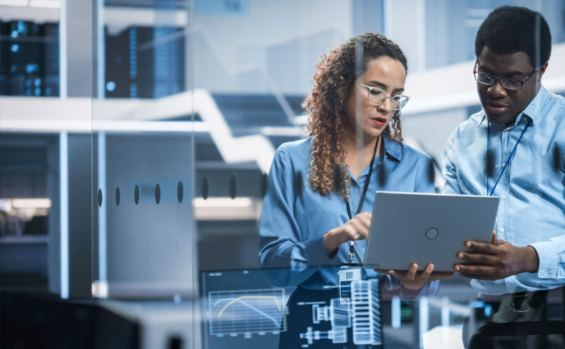 A man and a woman looking at a tablet