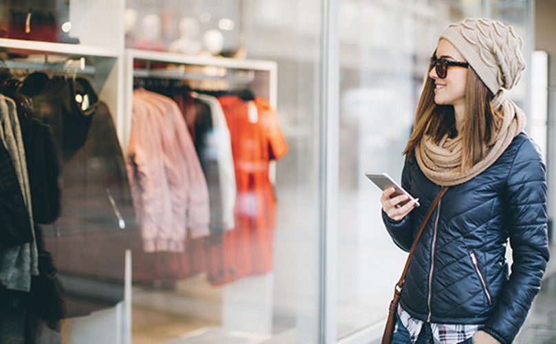 A person looking at a store window