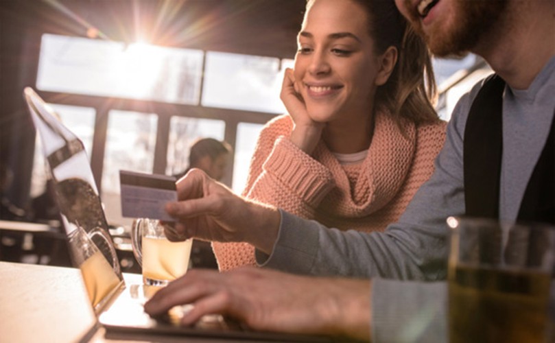 A person and person smiling at a table
