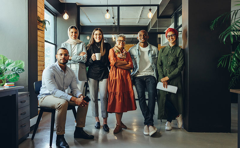 A group of people together at the office.