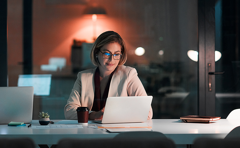 Woman in office looking at her laptop