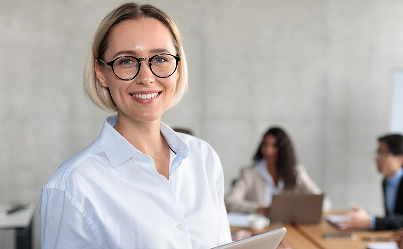 Image of business woman wearing glasses and holding a tablet