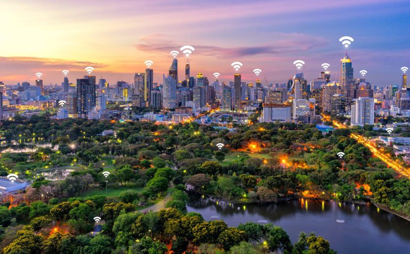An image of a city's skyline at sunset with wifi symbols on top of each building