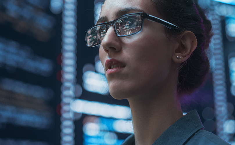 Image of woman wearing glasses in a data centre