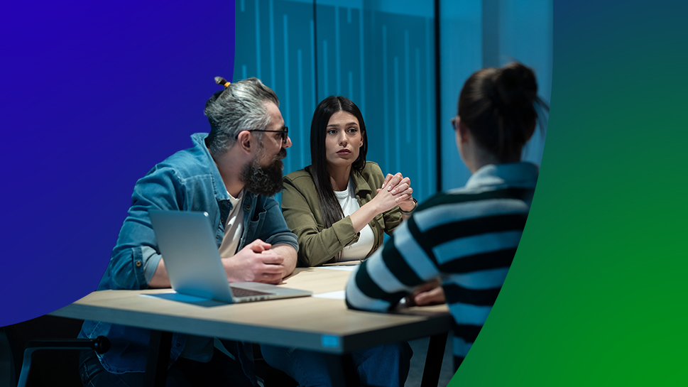 Colleagues sitting at a table in the office