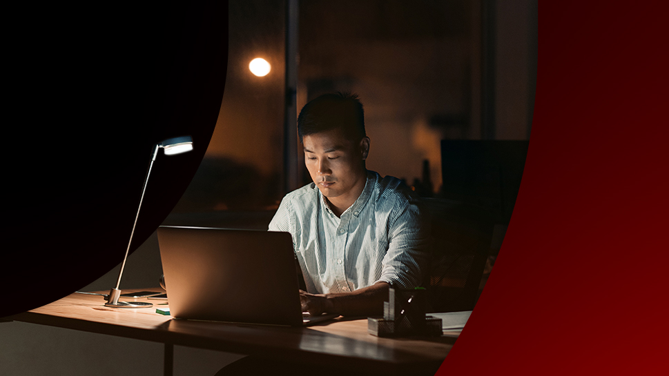 A man working at his computer in his office depicting threat intelligence