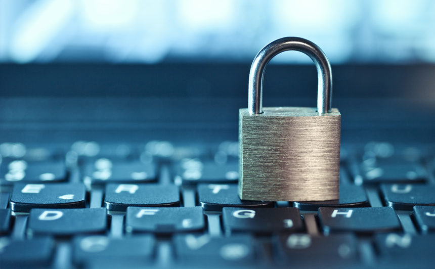 Close up shot of a padlock on top of a computer keyboard
