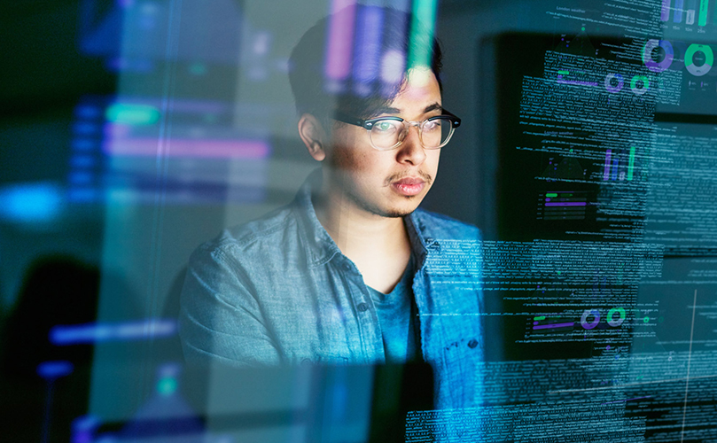 Person looking at a computer screen with data superimposed across the image