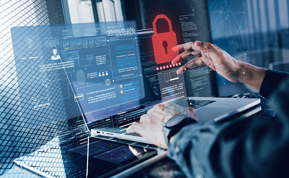 サイバーセキュリティの視覚化が施されたノートパソコンの画面を操作するユーザー。