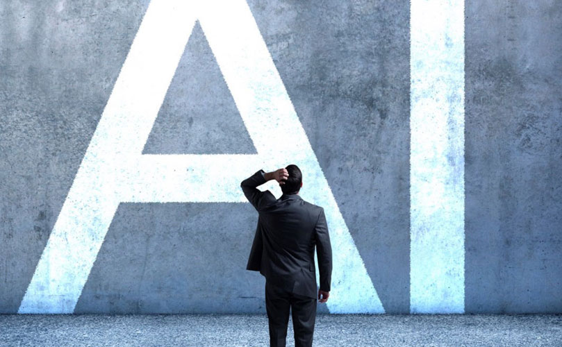 A man with a hand on his head looking at a wall that reads, in giant letters, 'AI'