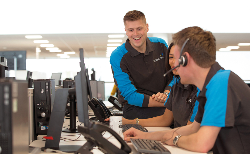 Two men working in an office laughing