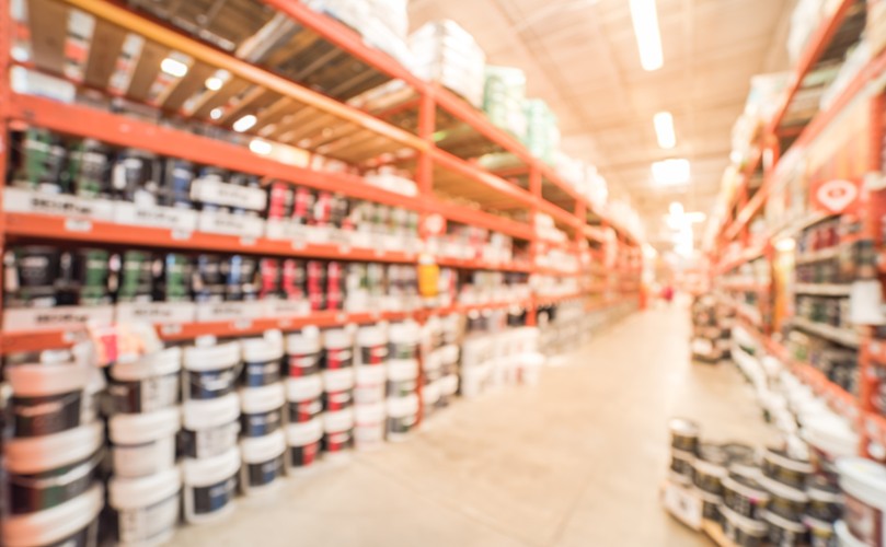 A warehouse with many buckets of paint.