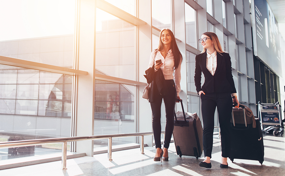 Two businesswomen walking in an airport