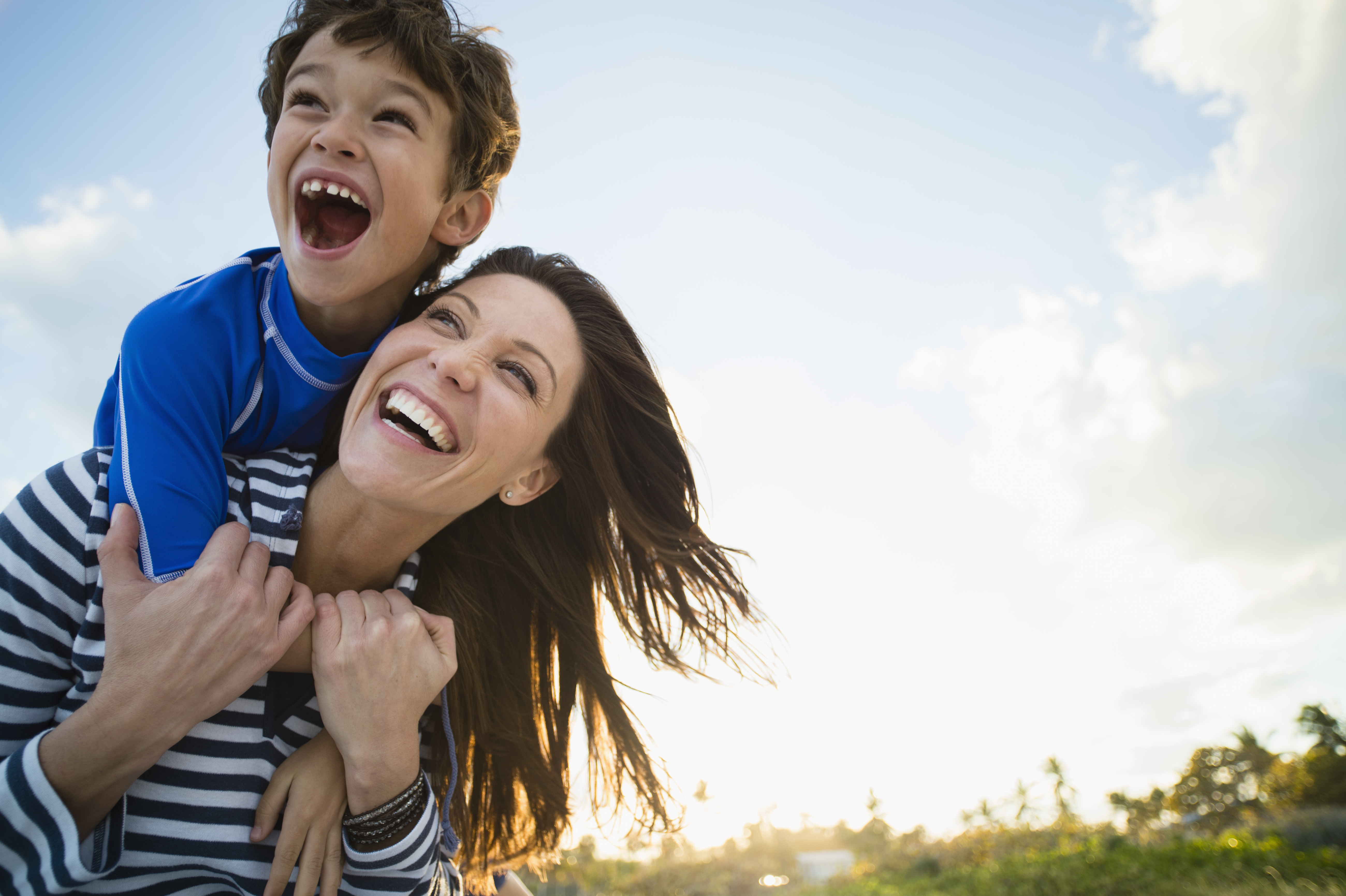 A woman carrying a young boy depicting healthcare interoperability
