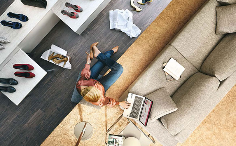 Split screen image: one side shows a woman lying on the floor surrounded by shoes and shopping bags, and the other side shows her using her laptop.