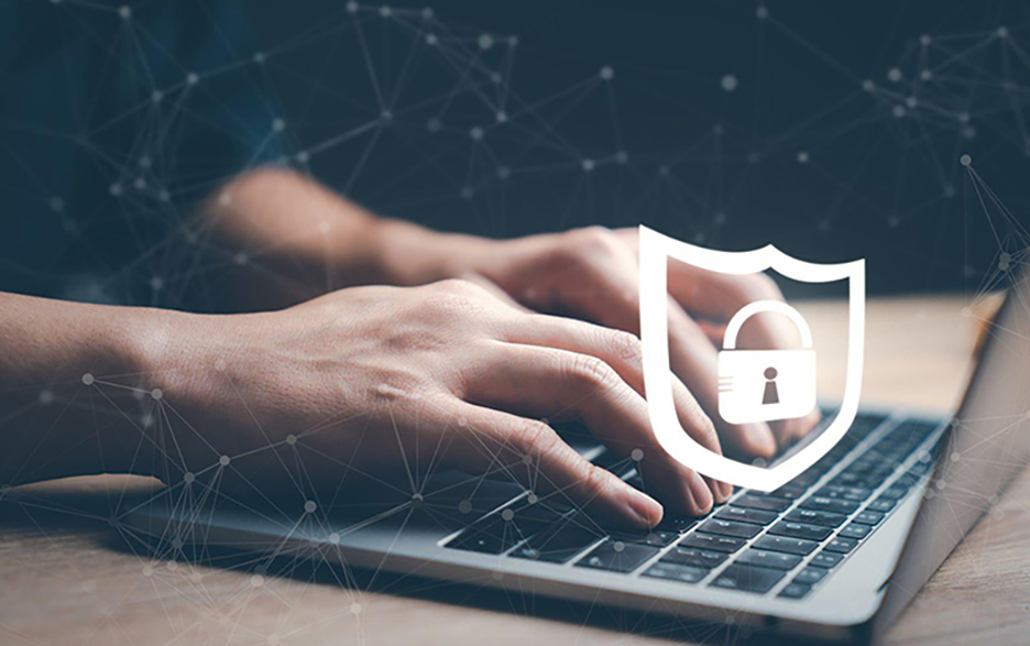 Typing on keyboard with lock icon depicting cyber security