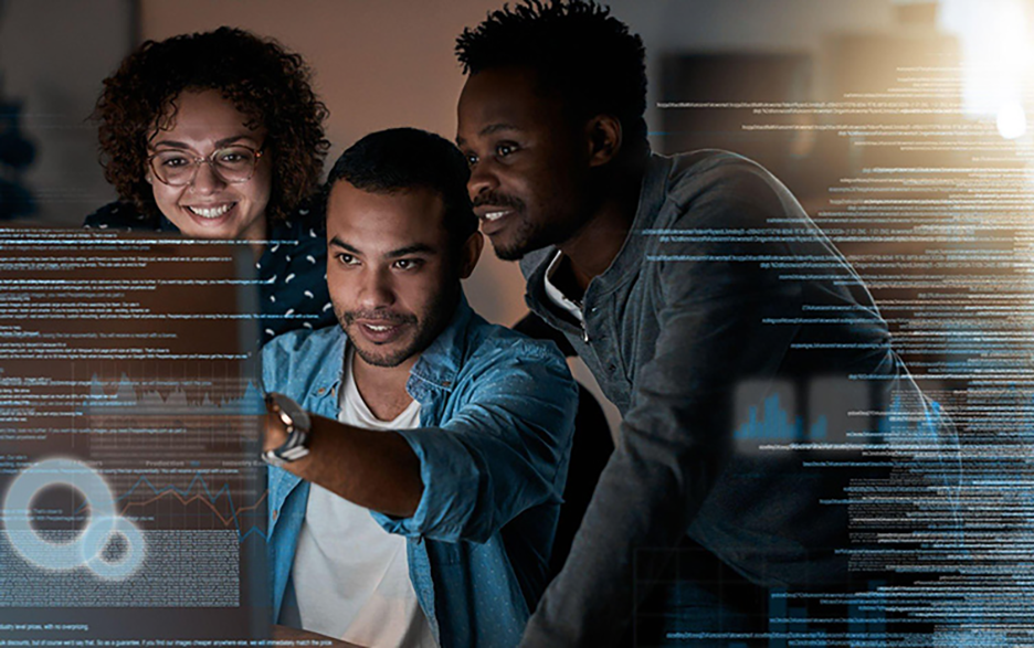 Three colleagues looking at a computer and analysing data