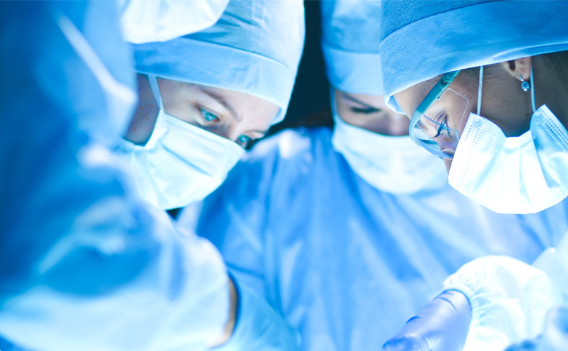 A picture doctors wearing mask during surgery.