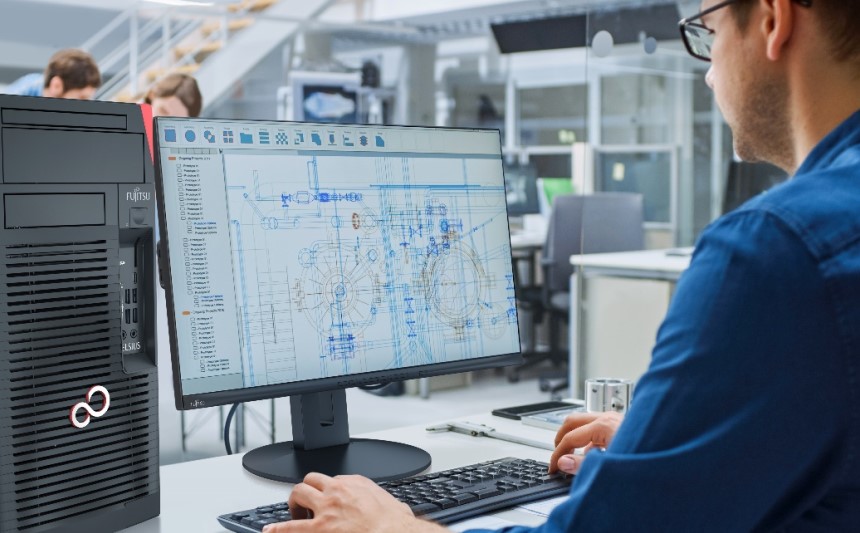 Un hombre trabajando en una computadora llena de gráficos