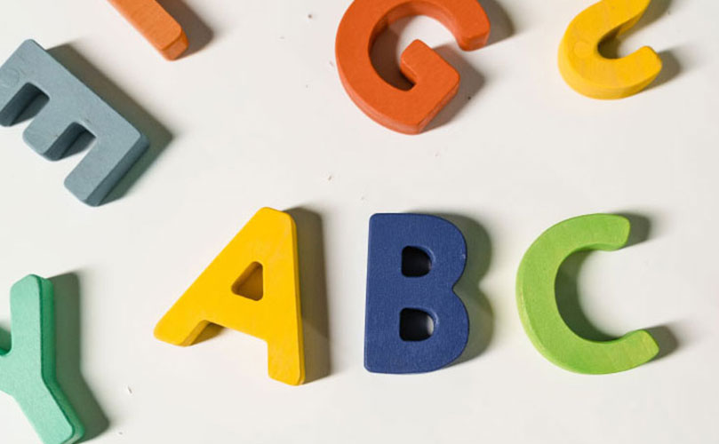 Three-dimensional alphabet letters in assorted colours sit against a white background.