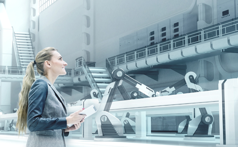 A focused woman holding a tablet in her hand, standing in a modern factory, attentively observing the surrounding machinery