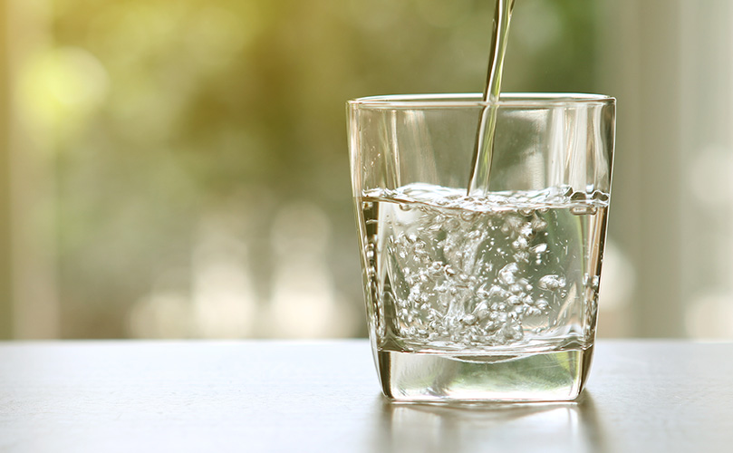 A glass of water being filled