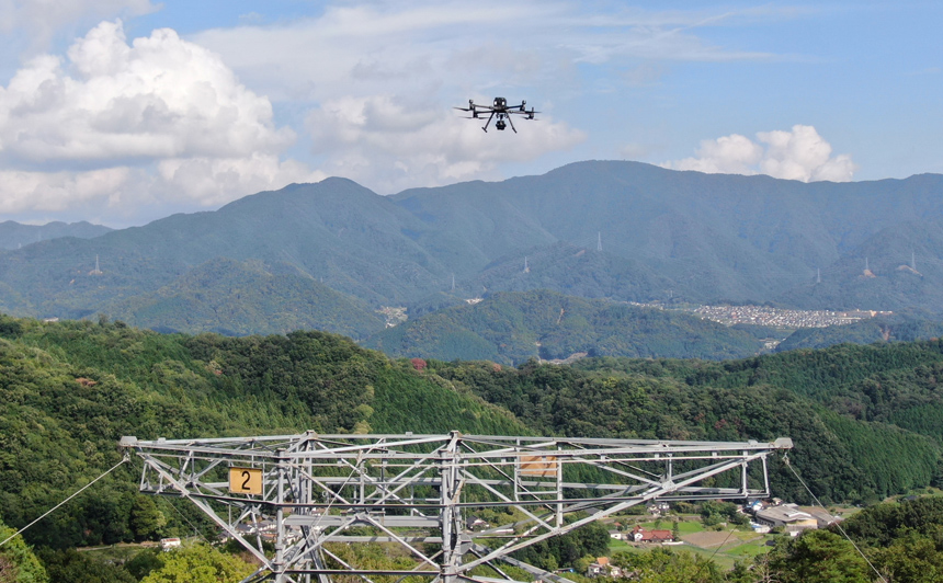 A mountain landscape with a drone in the sky