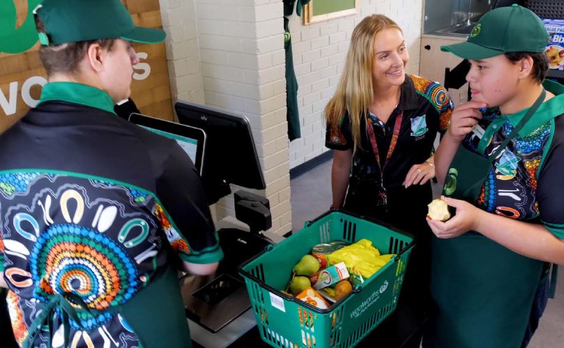 Three people working in a supermarket