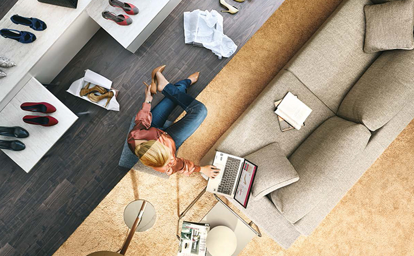 Split screen image: one side shows a woman lying on the floor surrounded by shoes and shopping bags, and the other side shows her using her laptop.