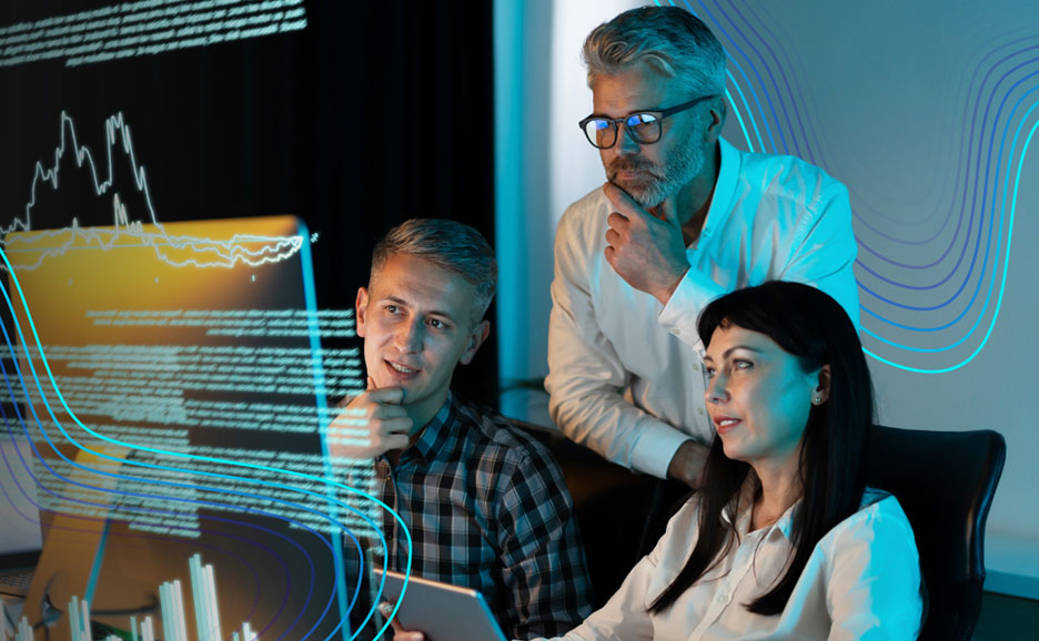 プロのチームが画面を覗き込み、データとグラフを分析しています。