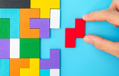 木製パズルピースを組み立てている手