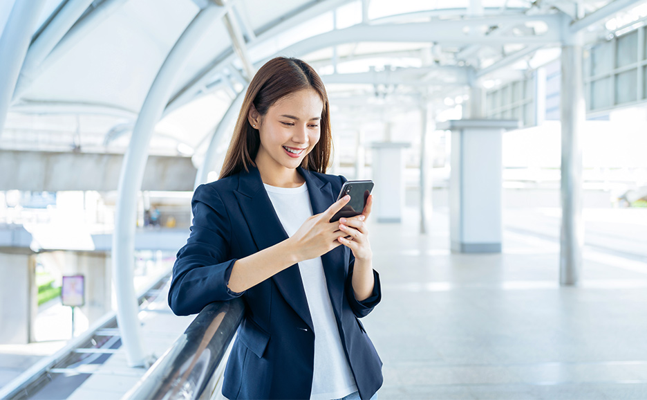 Smiling woman using smartphone