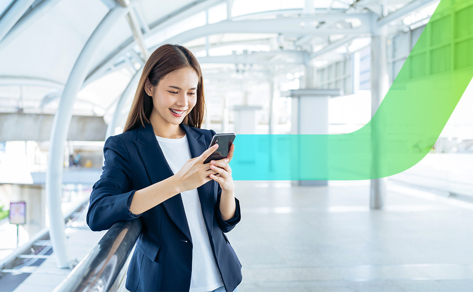 スマートフォンを操作し笑顔の女性