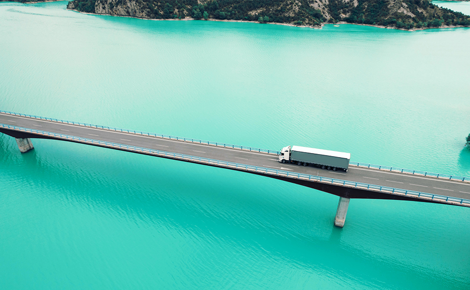 水域を横断する橋を走るトラック