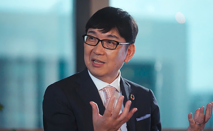 a man wearing glasses and a suit