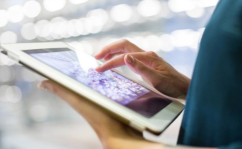  a person using a white tablet with a virtual keyboard