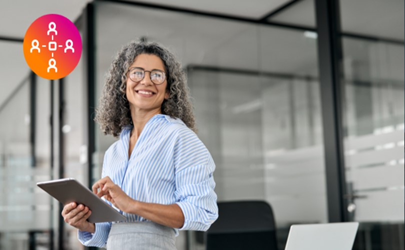 woman holding a tablet and smiling