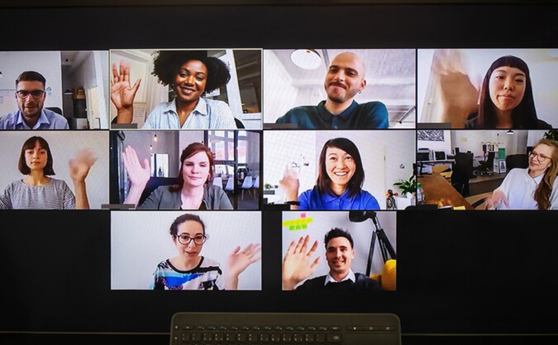 Several people on a video call, enthusiastically raising their hands, indicating engagement or a desire to speak.